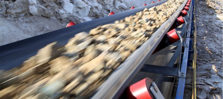 What are the signs of a misaligned conveyor belt?